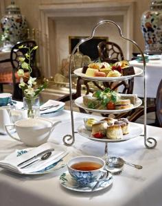a table with plates of food and cups of tea at The Omni King Edward Hotel in Toronto