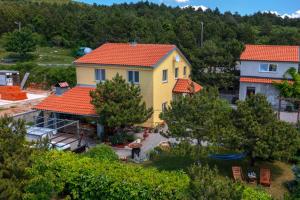 una casa amarilla con techo naranja en House Rukavina Senj en Senj