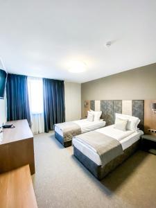 Ένα ή περισσότερα κρεβάτια σε δωμάτιο στο Hotel complex Jitomir