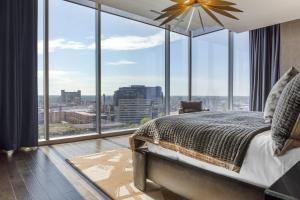 a bedroom with a bed and large glass windows at Omni Louisville Hotel in Louisville