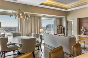a dining room with a table and chairs at Omni Louisville Hotel in Louisville
