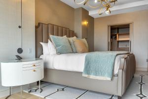 a bedroom with a large bed and a chandelier at Omni Louisville Hotel in Louisville