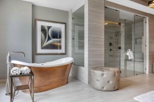 a bathroom with a tub and a shower at Omni Louisville Hotel in Louisville