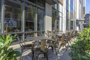 a row of tables and chairs on the side of a building at Omni Louisville Hotel in Louisville