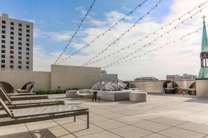 a patio with chairs and tables on a building at Omni Louisville Hotel in Louisville