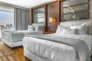 a hotel room with two beds and a window at Omni Louisville Hotel in Louisville