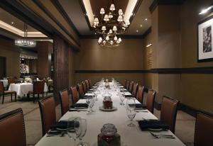 a dining room with a long table with wine glasses at Omni Louisville Hotel in Louisville