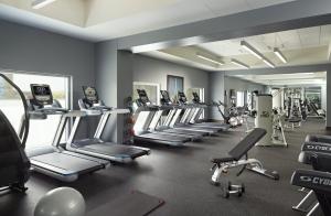 a gym with a row of treadmills and machines at Omni Louisville Hotel in Louisville