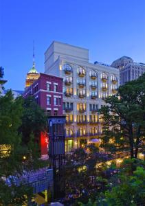 a building with lights on in a city at night at Mokara Hotel & Spa in San Antonio