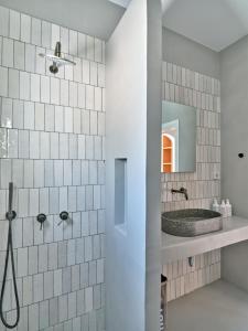 a bathroom with a sink and a mirror at Siora of Paros - Ammiralis & Castelis in Naousa