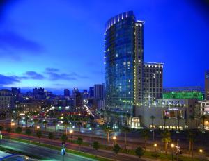 a city skyline at night with a tall building at Omni San Diego Hotel in San Diego
