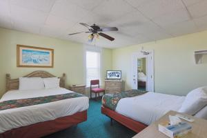 a hotel room with two beds and a ceiling fan at Shoreham Oceanfront Hotel in Ocean City