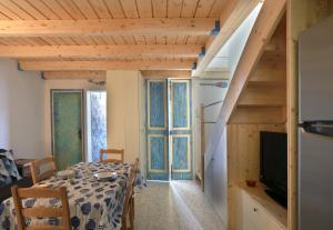 a dining room with a table with a television and a staircase at LaVí - Splendido appartamento sul mare in Nardò