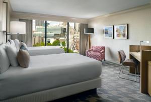 a hotel room with a bed and a desk at Omni Atlanta Hotel at Centennial Park in Atlanta