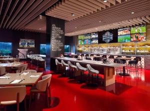 a restaurant with tables and chairs and a bar at Omni Atlanta Hotel at Centennial Park in Atlanta