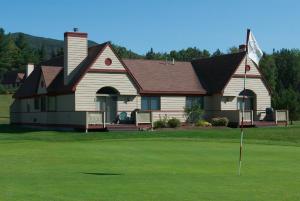 a house with a flag on a golf course at The Townhomes at Bretton Woods in Bretton Woods
