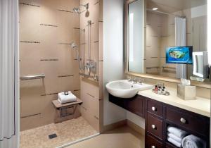 a bathroom with a sink and a toilet at Omni Dallas Hotel in Dallas