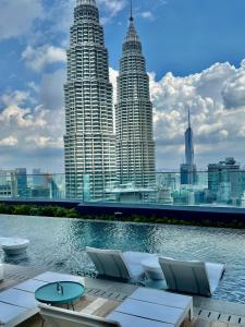 a view of the petronas twin towers from a hotel pool at Star Residence KLCC By FZB in Kuala Lumpur