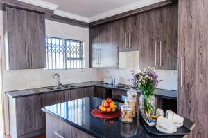 a kitchen with a bowl of fruit on a counter at Esther Guest House in Bethlehem