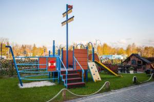 a park with a playground with a slide and slides at Willa ROZA in Łeba
