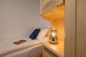 a small bedroom with a bed with a candle on a table at Wierchowe Apartamenty in Leśnica