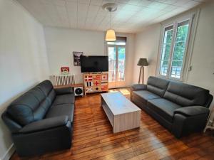 a living room with a couch and a coffee table at Maison Val de Cher in Noyers-sur-Cher