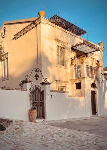 a white building with a gate and a fence at Carpofoli Corfu in Corfu Town