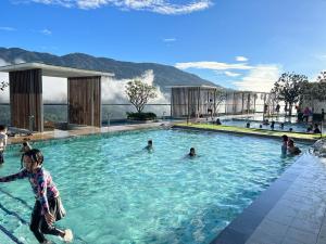 a group of people playing in a swimming pool at Windmill Upon Hills by Homespire in Genting Highlands