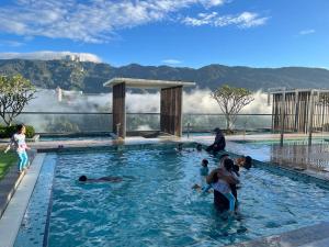 a group of people in a swimming pool at Windmill Upon Hills by Homespire in Genting Highlands