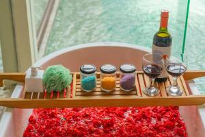 a tray with a bottle of wine and glasses on a table at Lalasa Villas Canggu in Canggu