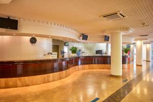 a lobby of a hospital with a bar at Don Juan Resort Affiliated by FERGUS in Lloret de Mar
