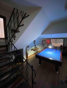 a pool table in a living room with a staircase at Villa Defne in Tekirdağ