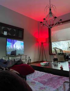 a living room with a tv and red lighting at Villa Defne in Tekirdağ