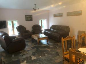 a living room with couches and a coffee table at The Falcon Inn Retreat in Aberdare