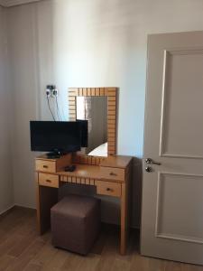 a desk with a television and a mirror in a room at Lavender House 1 - Agios Nikitas in Agios Nikitas