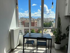 a blue table and two chairs in front of a window at VIP Квартира в центрі м. Івано-Франківськ in Ivano-Frankivsʼk