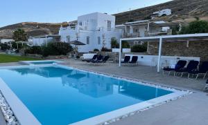 a swimming pool with blue water in front of a house at Antiparos View in Antiparos