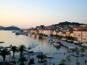 a view of a town with boats in the water at Apartments Bellus Mare in Mali Lošinj