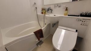a small bathroom with a toilet and a sink at Kyoto Crystal Hotel Ⅲ in Kyoto