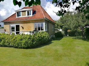 a brick house with a window and a grass yard at Room in a Danish cottage with garden view, 10 min to CPH in Gentofte