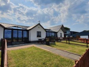 a house with a picnic table and a fence at The Calf Suite in Aberystwyth