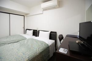 Postel nebo postele na pokoji v ubytování Business Inn Sennichimae Hotel + 37 fotografií