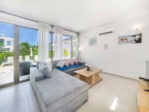 a living room with a couch and a table at Kymma Villa #16 in Ayia Napa