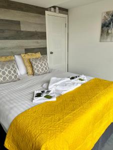 a bedroom with a large bed with towels on it at Whitsand Bay Tamar Suite in Downderry