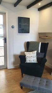 a living room with a couch and a chalkboard on the wall at Green Cottage - Snowdonia in Llanllechid