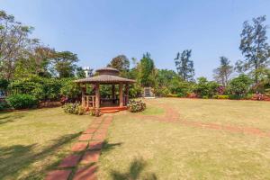 a gazebo in the middle of a grass field at StayVista's Valencia Villa with Gazebo and Indoor Games in Lonavala
