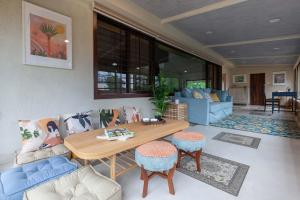 a living room with a wooden table and chairs at StayVista's Valencia Villa with Gazebo and Indoor Games in Lonavala