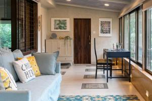 a living room with a couch and a table at StayVista's Valencia Villa with Gazebo and Indoor Games in Lonavala +39 photos