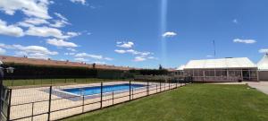 a swimming pool with a fence in front of it at Santiago León in León