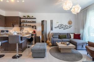 a living room with a blue couch and a kitchen at Lemon Tree 1-BR Apt in Livadia in Larnaka